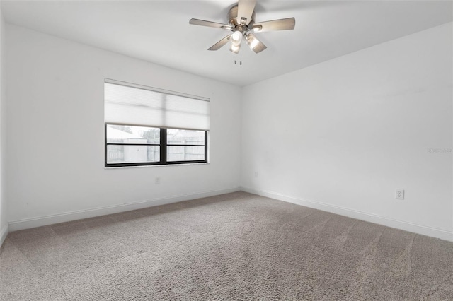 empty room with baseboards, a ceiling fan, and carpet flooring