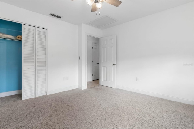 unfurnished bedroom with a closet, carpet flooring, baseboards, and visible vents