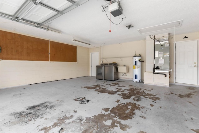 garage featuring heating unit, separate washer and dryer, a sink, electric water heater, and a garage door opener