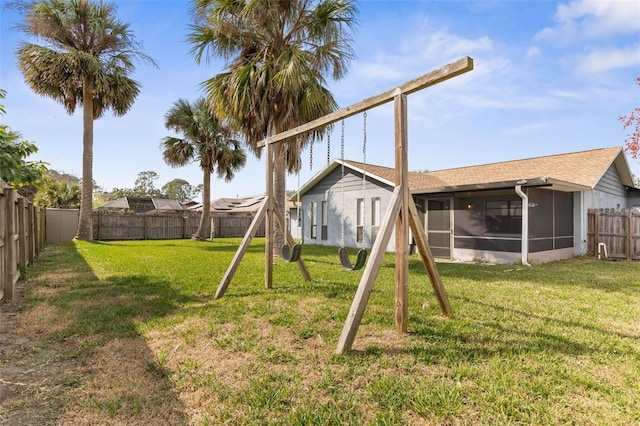 view of yard with a fenced backyard and a sunroom