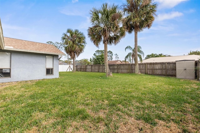 view of yard featuring an outdoor structure, a storage unit, and a fenced backyard