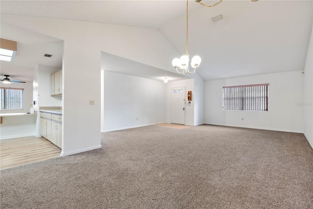 empty room with light carpet, lofted ceiling, and ceiling fan