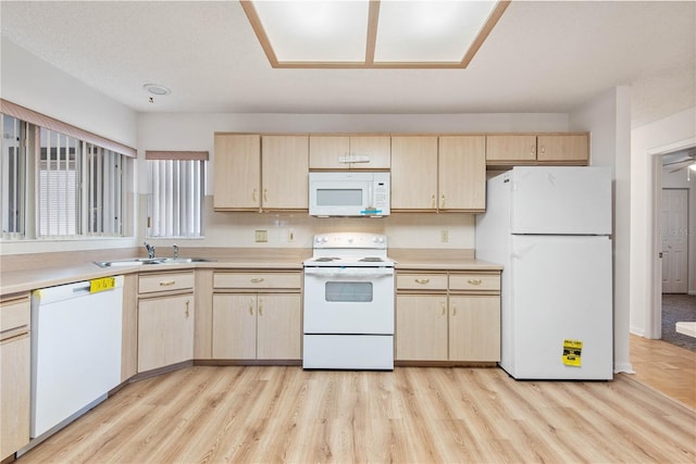 kitchen with white appliances, light hardwood / wood-style floors, sink, and light brown cabinets