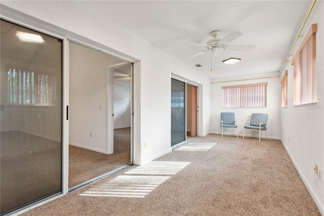 unfurnished bedroom with light colored carpet, a closet, and ceiling fan