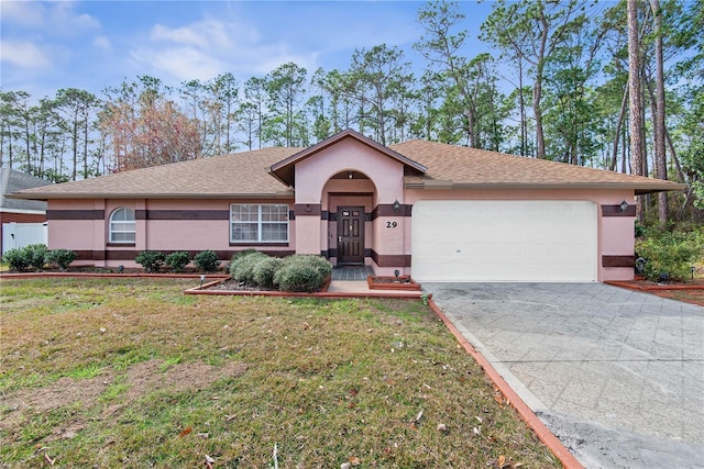 single story home featuring a garage and a front lawn