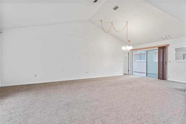 spare room featuring high vaulted ceiling, carpet, and a notable chandelier