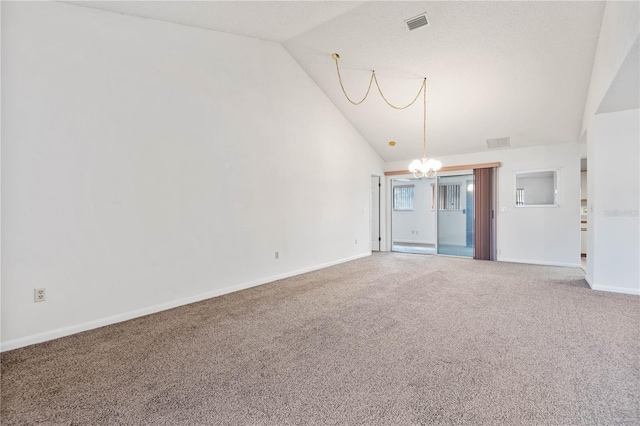 spare room featuring an inviting chandelier, carpet flooring, and high vaulted ceiling