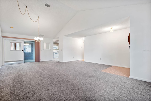 unfurnished living room with a chandelier, high vaulted ceiling, and light carpet