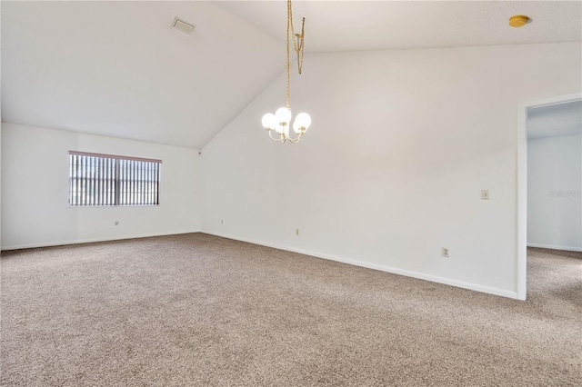 carpeted empty room featuring vaulted ceiling