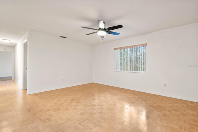 spare room featuring light parquet flooring and ceiling fan