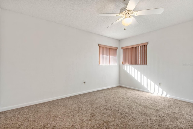 carpeted spare room with ceiling fan and a textured ceiling