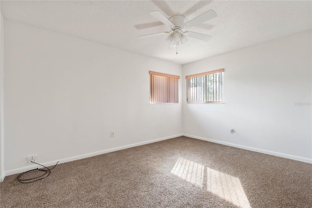 carpeted spare room with ceiling fan and a textured ceiling