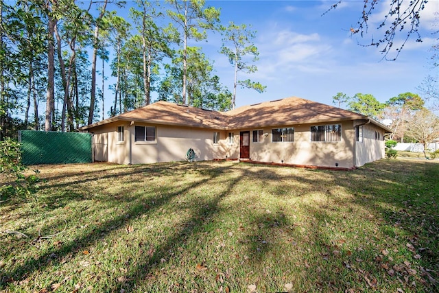 rear view of house with a yard