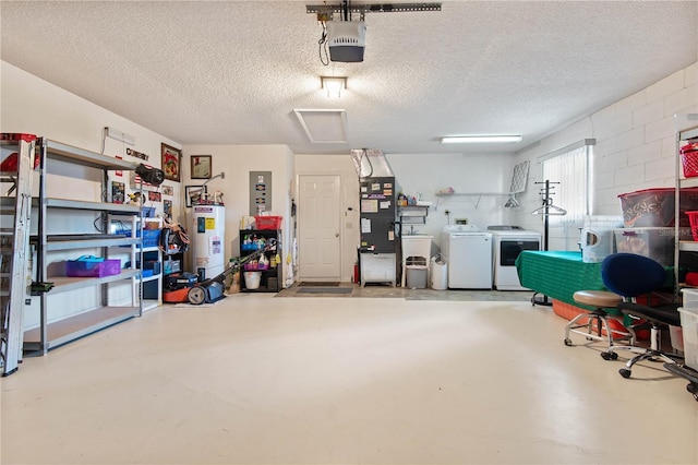 garage featuring water heater, washer and dryer, and a garage door opener