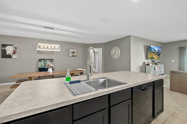 kitchen with light tile patterned flooring, decorative light fixtures, black dishwasher, sink, and a kitchen island with sink