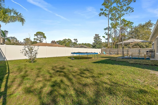 view of yard with a trampoline