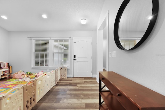 interior space with hardwood / wood-style floors and a textured ceiling