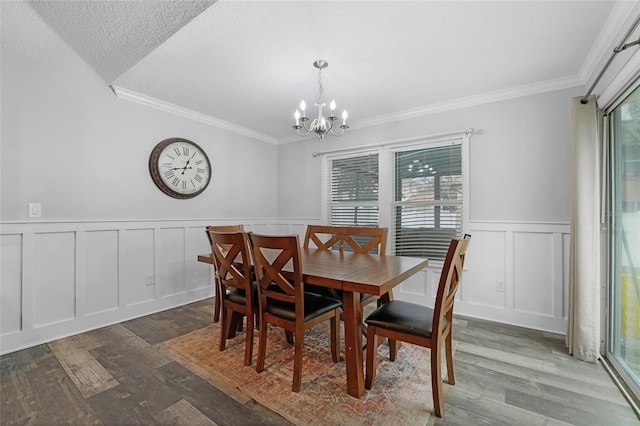 dining room with ornamental molding, dark hardwood / wood-style floors, and a notable chandelier