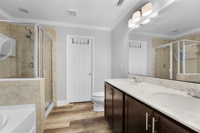 full bathroom with crown molding, hardwood / wood-style flooring, vanity, plus walk in shower, and toilet