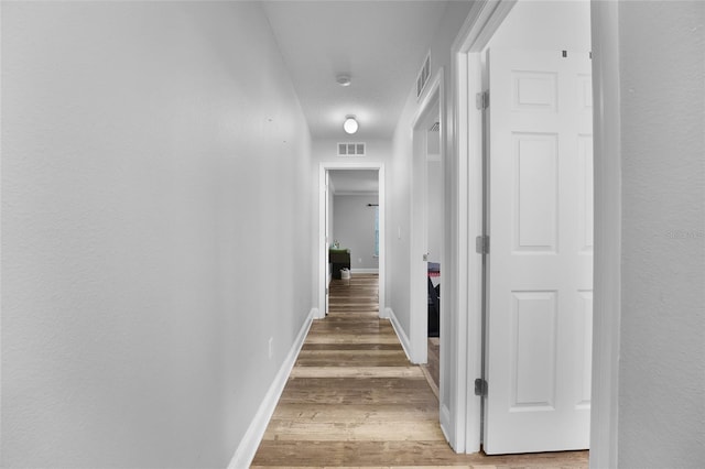 hall with hardwood / wood-style floors