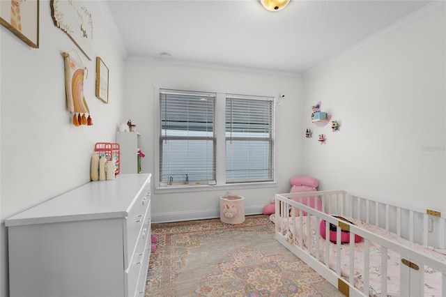 bedroom featuring a nursery area and crown molding