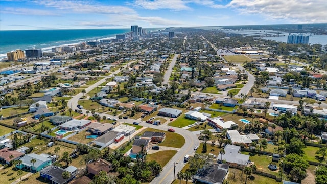 birds eye view of property featuring a water view and a city view