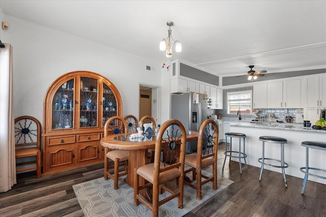 dining room featuring ceiling fan, visible vents, and dark wood-type flooring