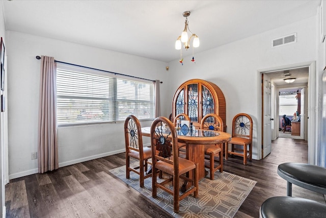 dining space with dark wood-style floors, a healthy amount of sunlight, visible vents, and baseboards