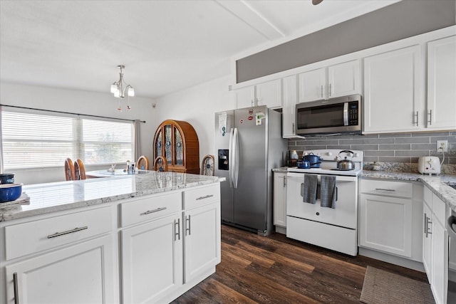 kitchen with stainless steel appliances, backsplash, dark wood-type flooring, white cabinetry, and light stone countertops