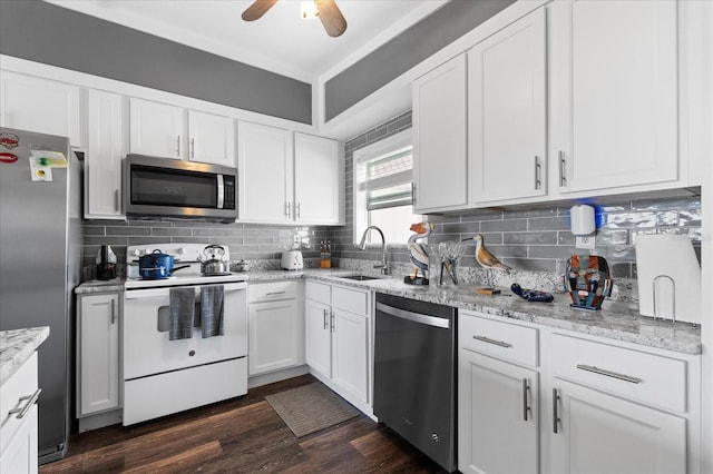 kitchen with backsplash, dark wood-style flooring, stainless steel appliances, and a sink