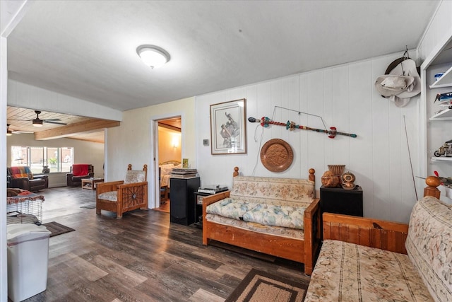 living room featuring ceiling fan, dark wood finished floors, and beam ceiling