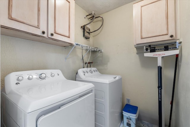 washroom with cabinet space and washing machine and clothes dryer