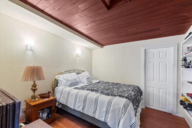 bedroom with wood ceiling and wood finished floors