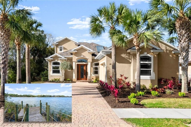 view of front of home featuring a water view and stucco siding