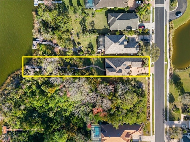 birds eye view of property with a residential view and a water view