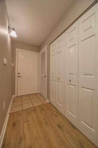 hall with hardwood / wood-style floors