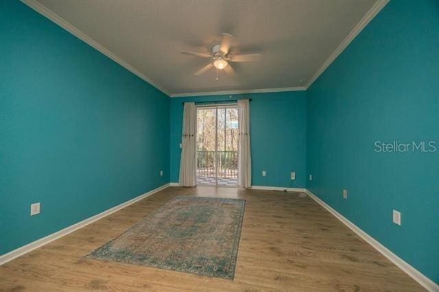 unfurnished room with crown molding, wood-type flooring, and ceiling fan