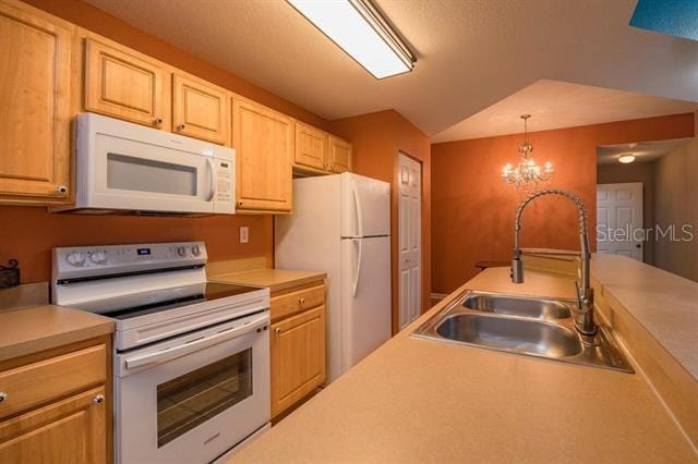 kitchen with sink, white appliances, an inviting chandelier, light brown cabinetry, and decorative light fixtures