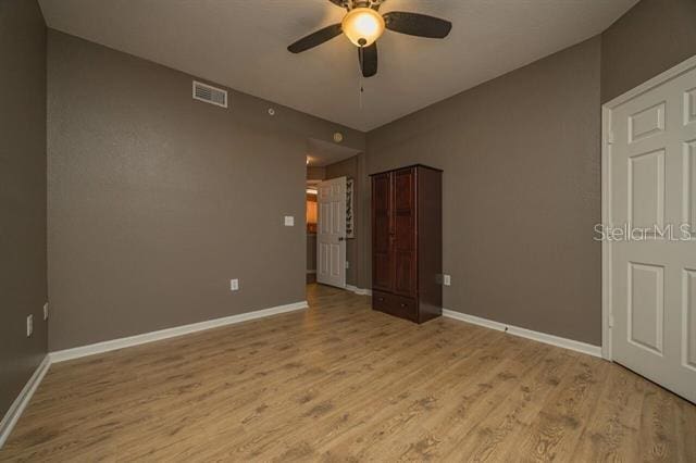 unfurnished bedroom featuring ceiling fan and light hardwood / wood-style floors