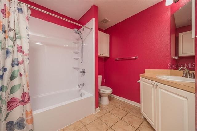 full bathroom featuring tile patterned flooring, vanity, shower / bathtub combination with curtain, and toilet