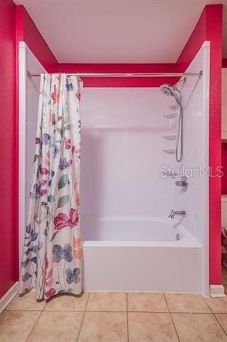 bathroom featuring tile patterned flooring and shower / bath combo with shower curtain