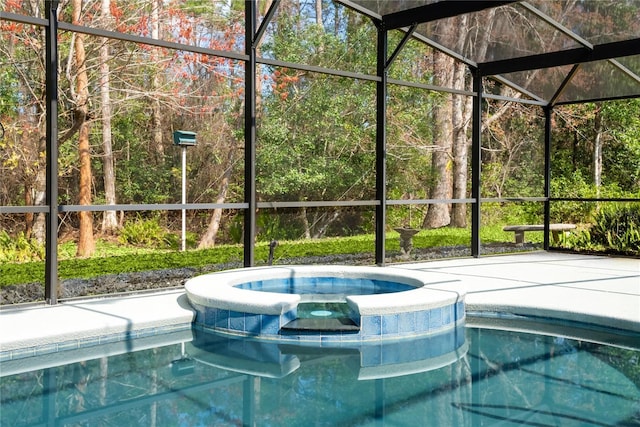 view of swimming pool with an in ground hot tub