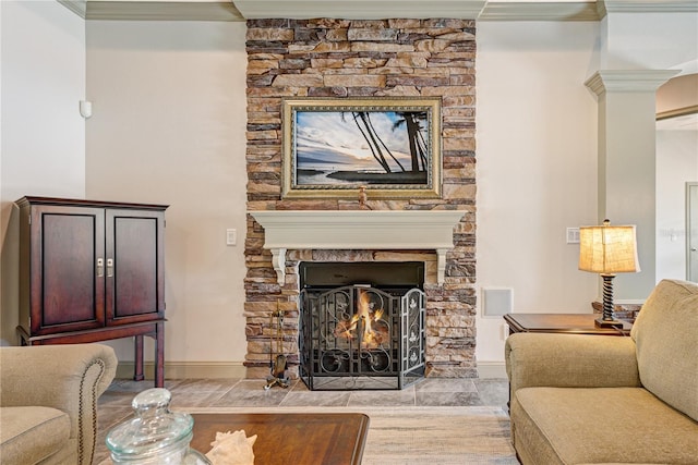 living room with a fireplace and decorative columns