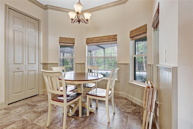 dining room with a notable chandelier and crown molding