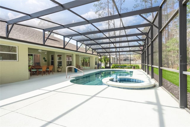 view of swimming pool featuring a lanai, a patio area, and an in ground hot tub