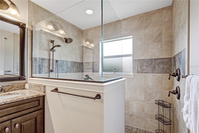 bathroom with vanity and tiled shower