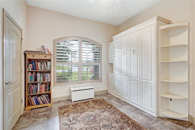 living area with ceiling fan and built in features