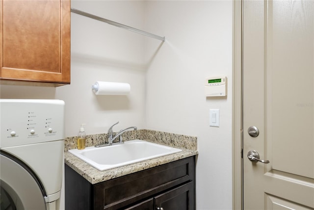 washroom with washer / clothes dryer, sink, and cabinets