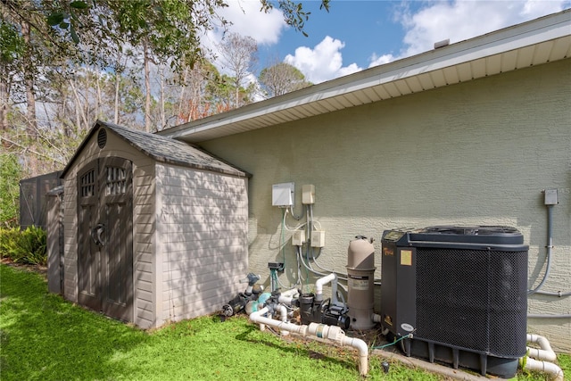 view of property exterior with a yard, central AC, and a storage unit