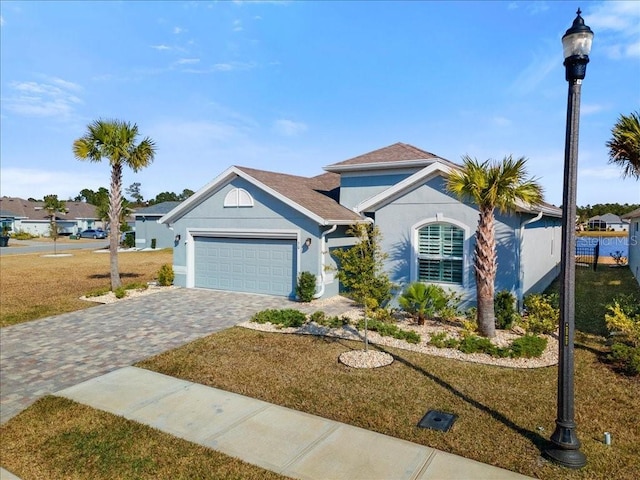 view of front of property with a garage and a front yard